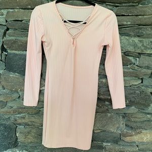 Tight pastel pink ribbed dress and ties on the top